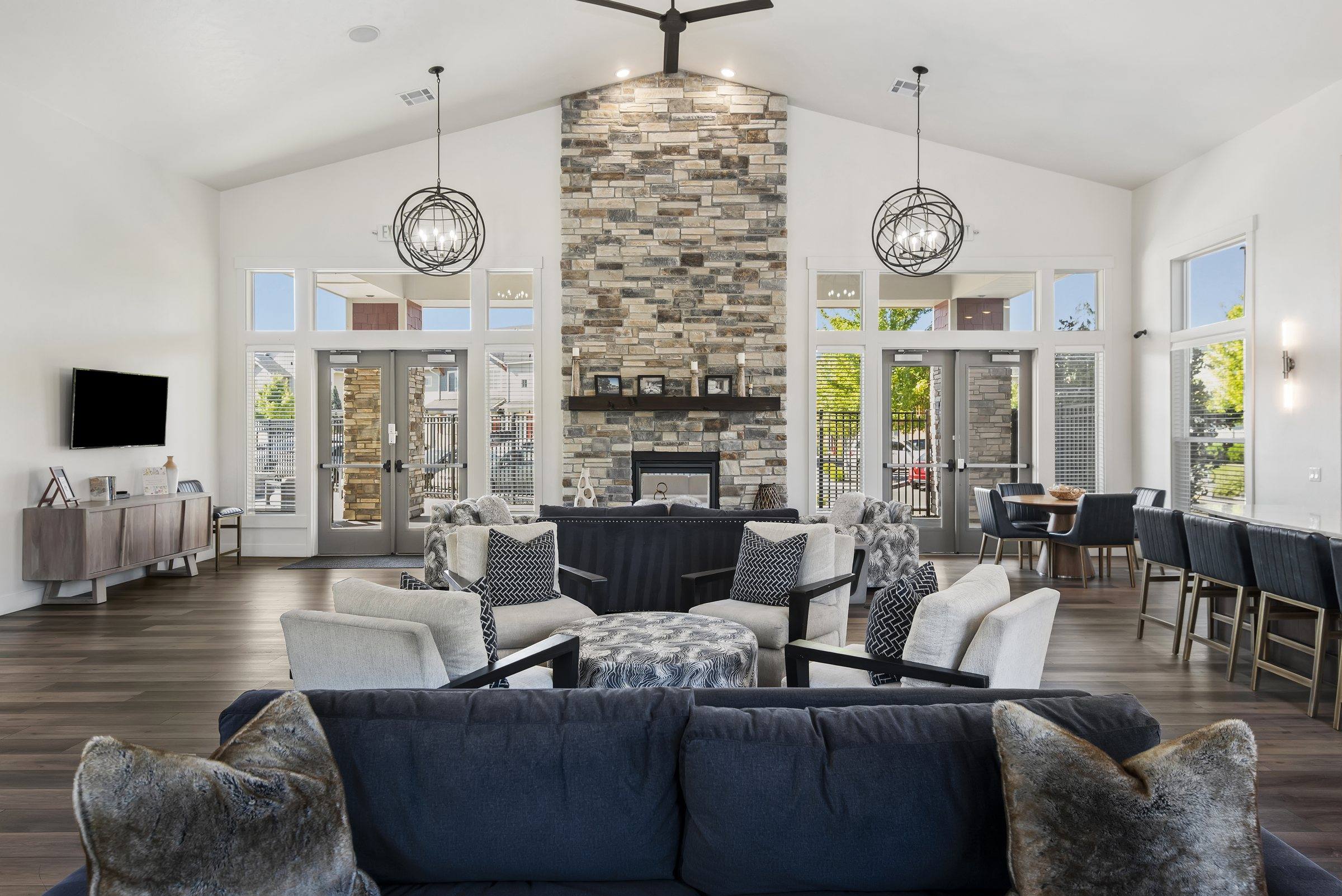 The resident clubhouse lounge with a stone fireplace and seating