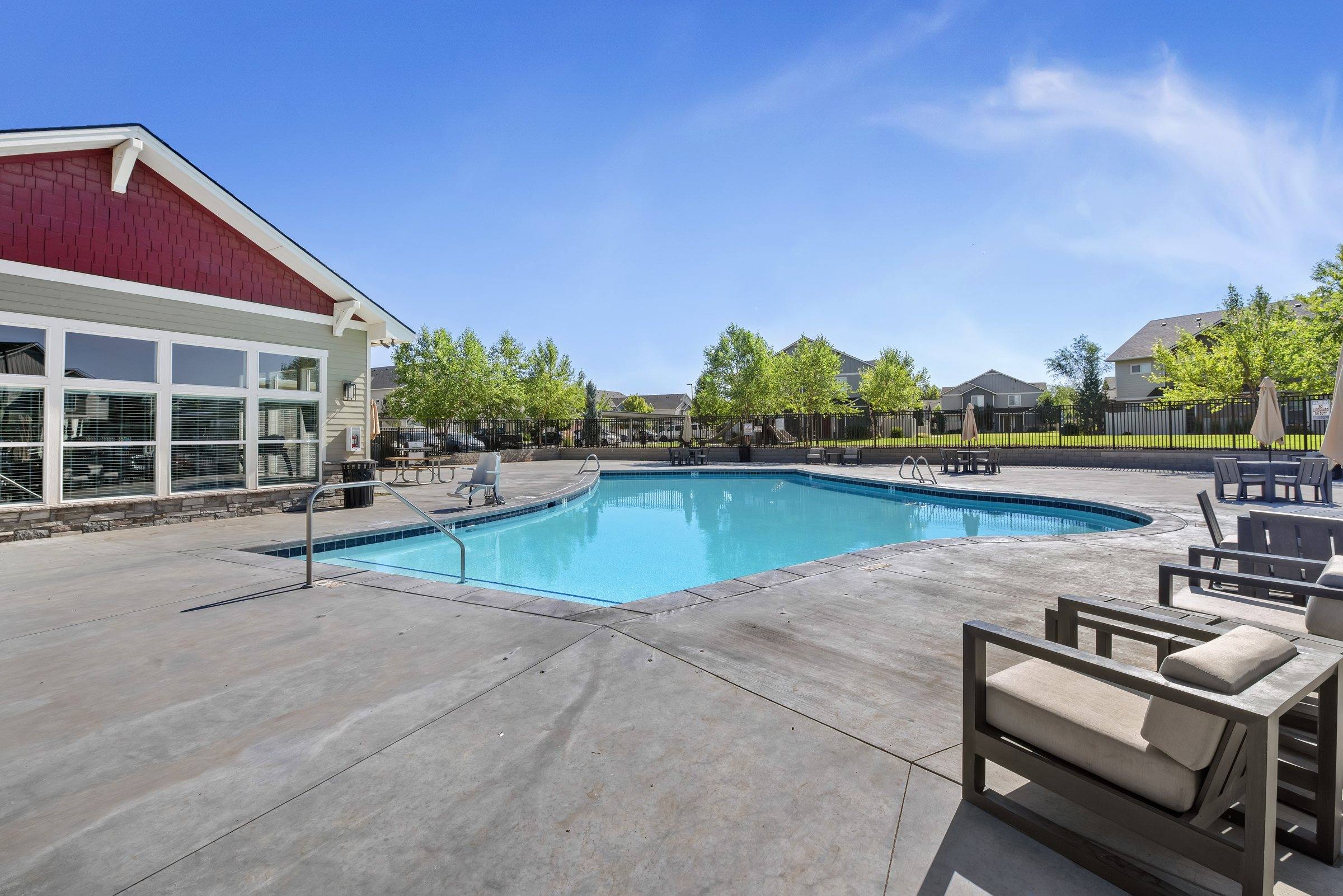 The resort-style pool and sun deck with lounge seating