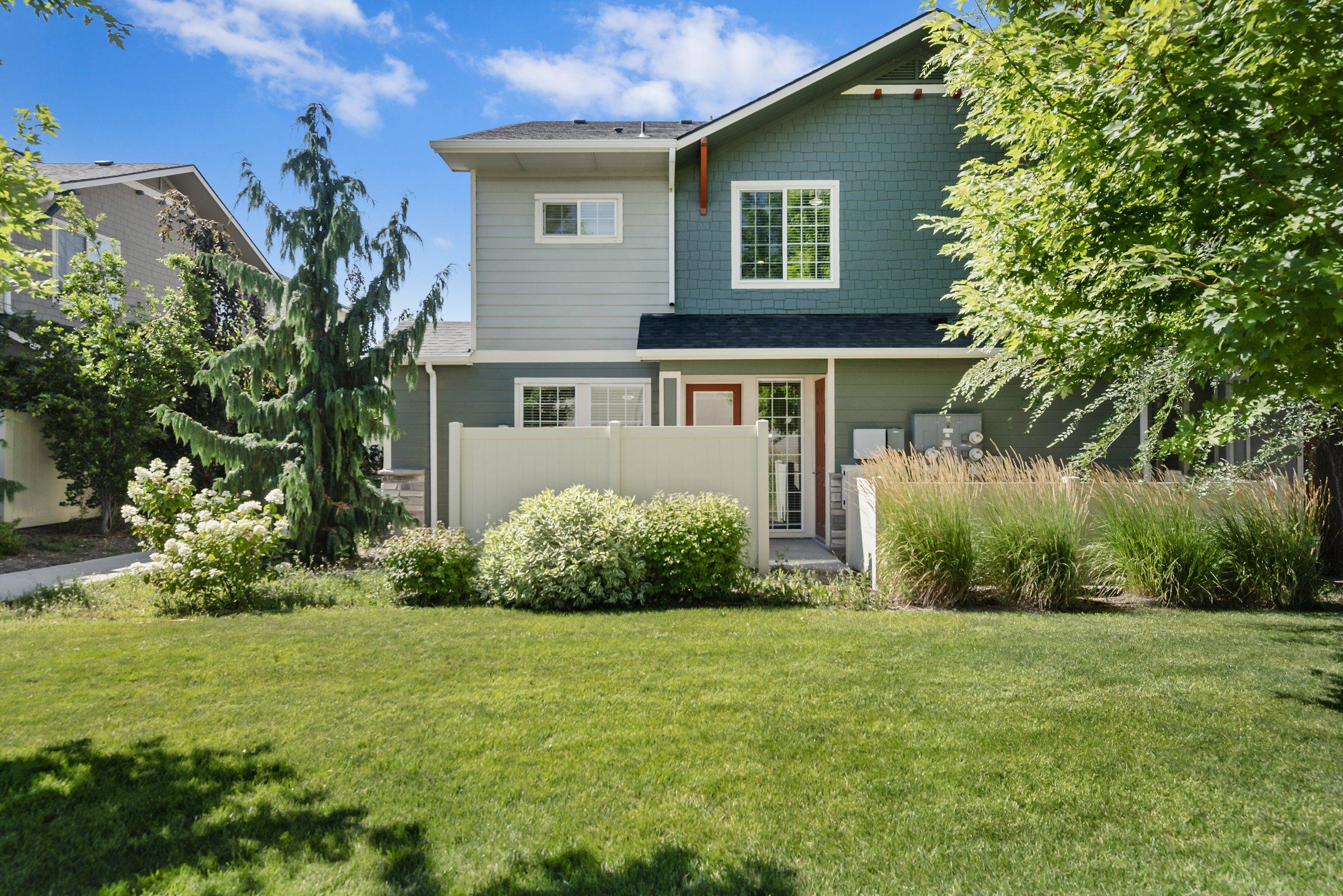 The Enclave townhome architecture with mature landscaping