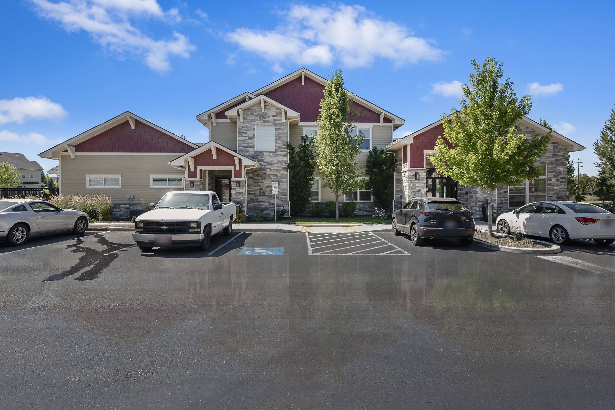 Craftsman-style townhome buildings and resident parking at The Enclave