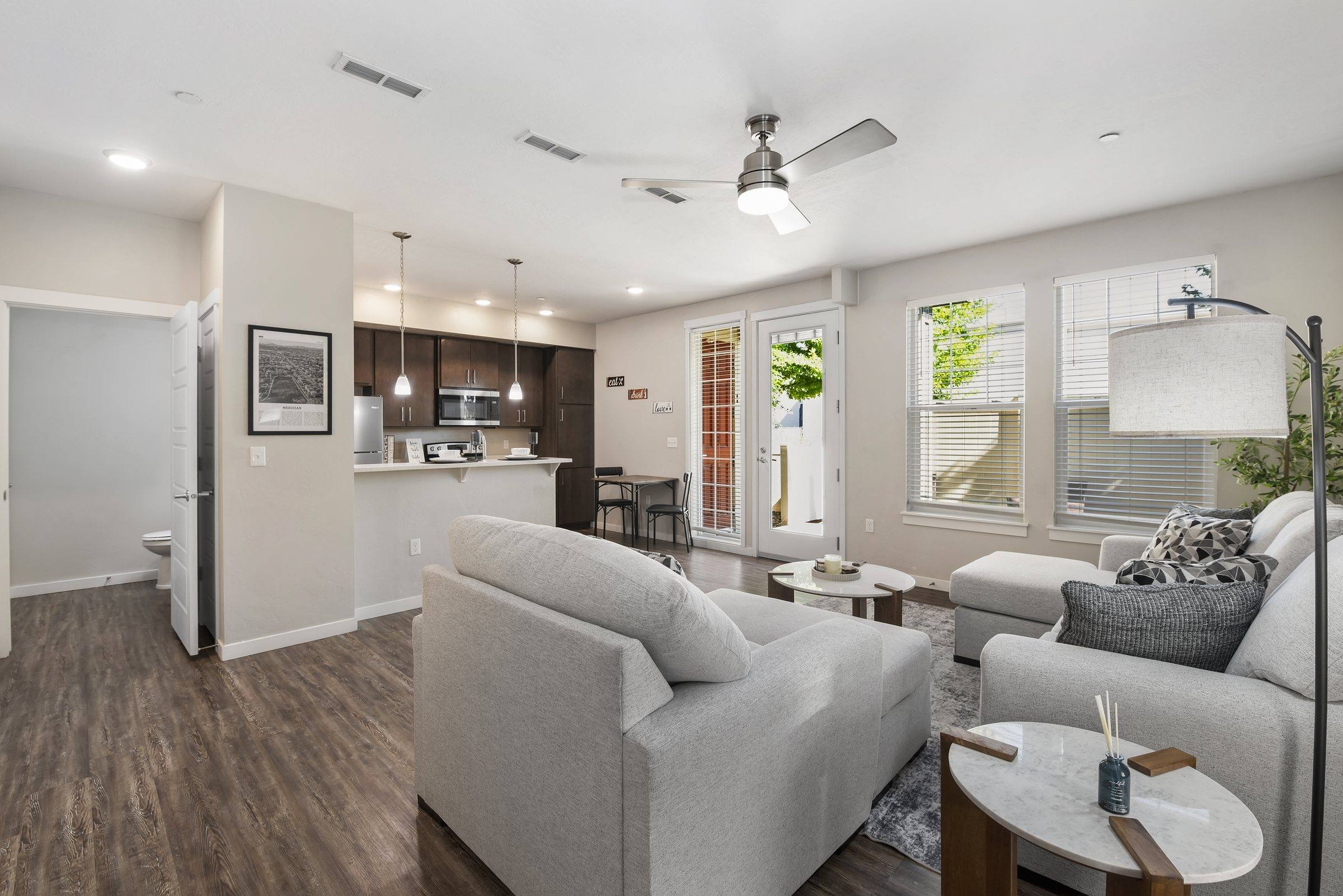 Furnished living room open to the kitchen in a model townhome